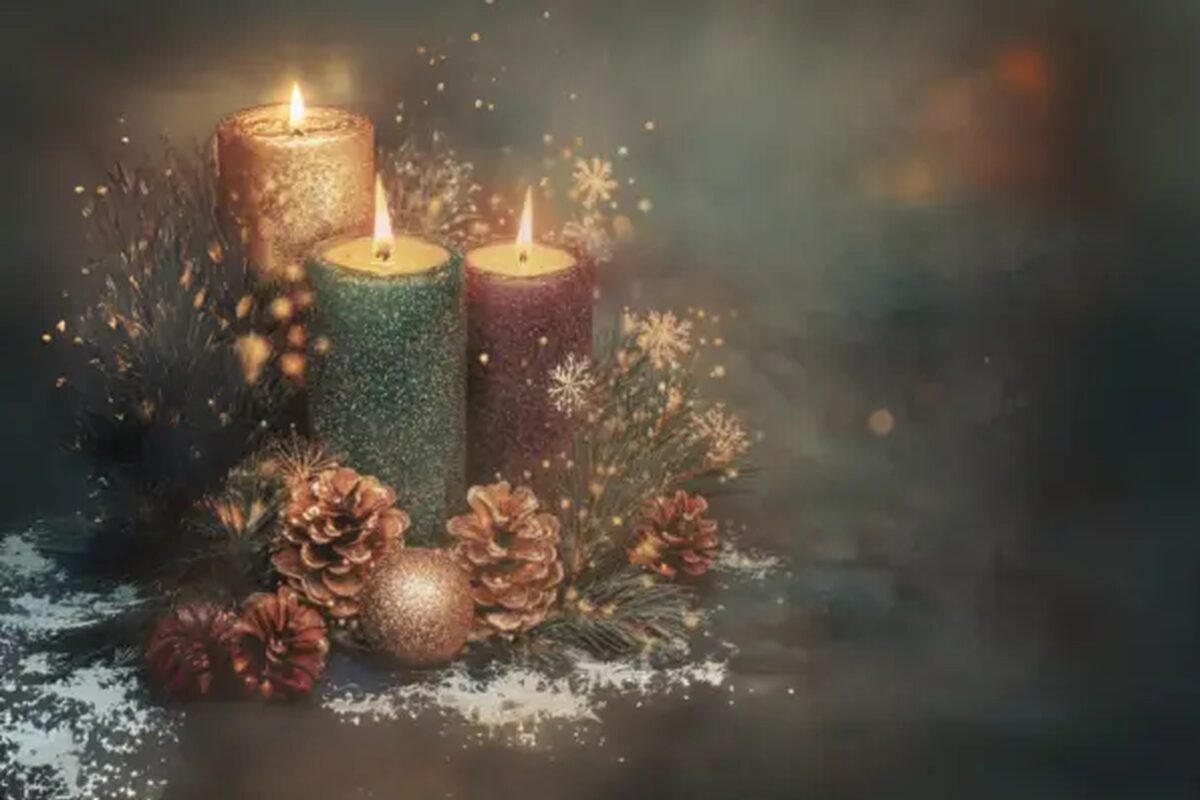 Advent candles glowing softly with evergreen branches and pinecones, symbolizing light meant to be shared through kindness, hope, and presence.